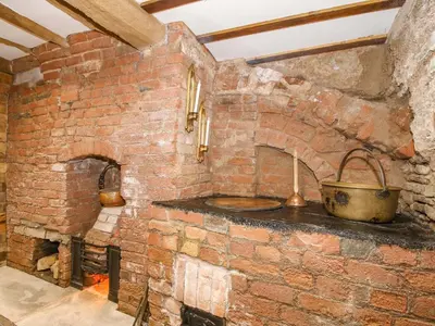 a brick oven with a pot on a stone wall at Raven Lane Retreat in Ludlow