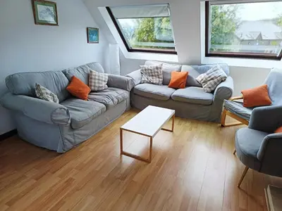 a living room with two couches and a table at Sisial y Llyn in Bala