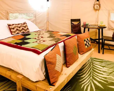 a bed with many pillows on it in a room at Taylor the Burt in Penuwch