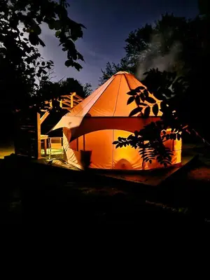 a large tent is lit up at night at Taylor the Burt in Penuwch