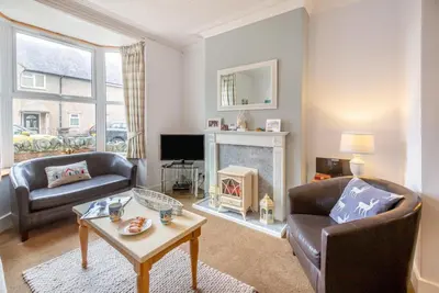 a living room with two chairs and a fireplace at 4 Bed in Barmouth oc-n32921 in Barmouth