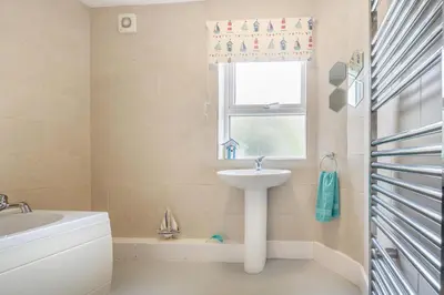 a bathroom with a sink and a window at 4 Bed in Barmouth oc-n32921 in Barmouth