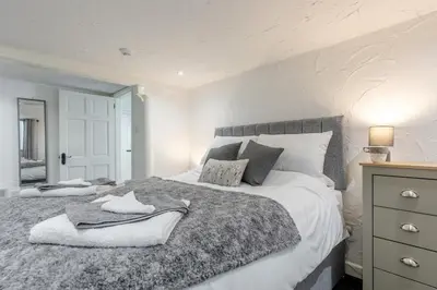 a bedroom with a large bed and a mirror at 1 Bed in Capel Bangor oc-y33024 in Capel Bangor