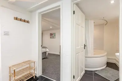 a white bathroom with a tub and a sink at 1 Bed in Capel Bangor oc-y33024 in Capel Bangor