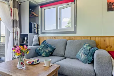 a living room with a couch and a table at 1 Bed in Llandeilo oc-w33068 in Llanddeusant