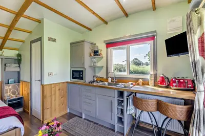 a kitchen with a counter with a sink and a window at 1 Bed in Llandeilo oc-w33068 in Llanddeusant
