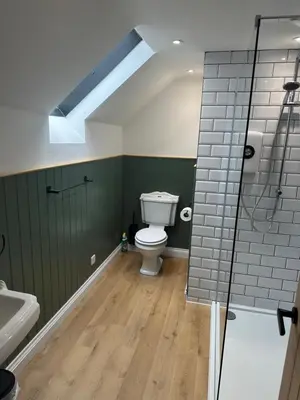 a bathroom with a toilet and a sink and a shower at The Swan in Munslow
