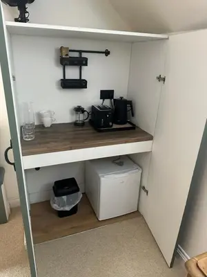 a room with a shelf with a coffee maker on it at The Swan in Munslow