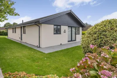 a white house with a black roof at 4 Bed in Brecon oc-m32973 in Brecon