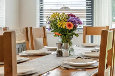 a table with a vase of flowers on it at 4 Bed in Brecon oc-m32973 in Brecon