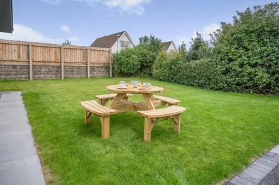 a picnic table and two benches in a yard at 4 Bed in Brecon oc-m32973 in Brecon