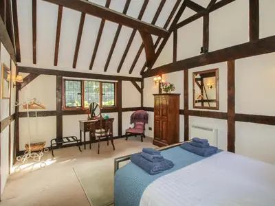 a bedroom with a bed and a desk in a room at The Coach House in Church Stretton