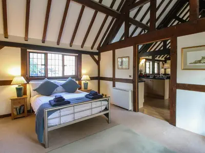 a bedroom with a bed with a table in it at The Coach House in Church Stretton