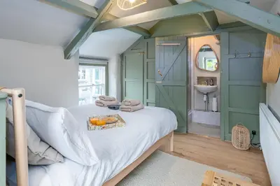 a bedroom with green walls and a bed with a table at Charming Welsh Cottage in Dolgellau - Snowdonia in Dolgellau