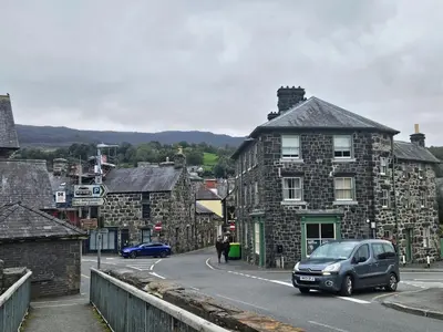 a car driving down a street in a small town at Charming Welsh Cottage in Dolgellau - Snowdonia in Dolgellau