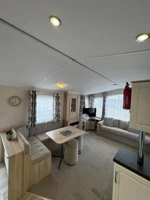 a living room with a couch and a table at T&J Seaview at Pengarreg in Llanrhystyd