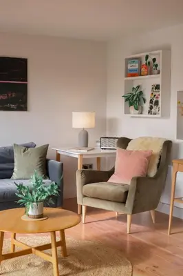 a living room with a couch and a desk at Amberwood Lodge in Hay-on-Wye