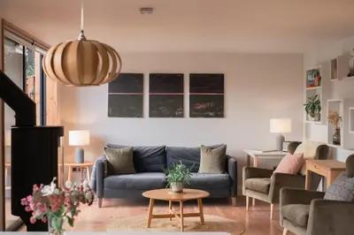 a living room with a couch and a table at Brackenfell Lodge in Hay-on-Wye