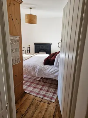 a bedroom with a bed and a fireplace at Rustic Welsh cottage in Llanwrtyd Wells