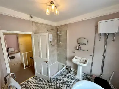 a bathroom with a shower and a sink at Victorian Town House Shrews in Shrewsbury