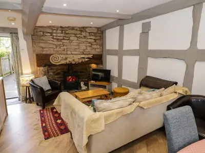 a living room with a couch and a fireplace at Middle Cottage in Ludlow
