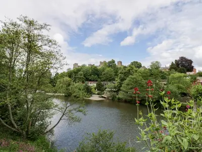 a view of a river with a city in the background at Middle Cottage in Ludlow