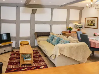 a living room with a couch and a table at Middle Cottage in Ludlow