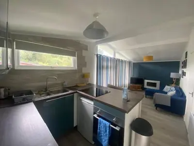 a kitchen with a sink and a couch in a room at Chalet 8 Erw Porthor Happy valley in Tywyn