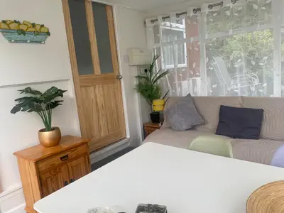 a living room with a couch and a window at Chalet 8 Erw Porthor Happy valley in Tywyn