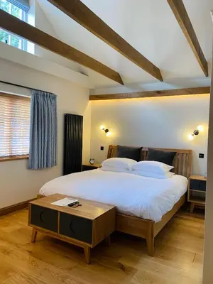 a bedroom with a large bed and a table at Sebastians in Oswestry