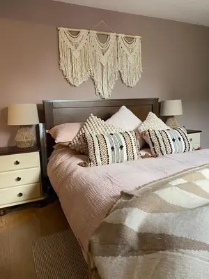 a bedroom with a bed with pillows and a chandelier at Studio Twelve in Brecon