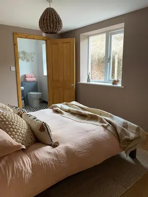 a bedroom with a bed and a window and a door at Studio Twelve in Brecon