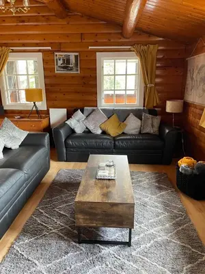 a living room with a couch and a coffee table at IVY Cabin in Trawsfynydd