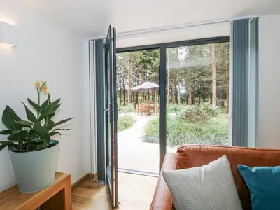 a living room with a sliding glass door leading to a patio at The Barn in Bishops Castle