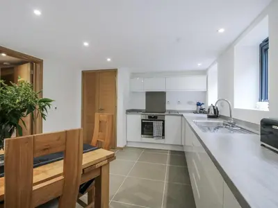 a kitchen with white cabinets and a counter top at The Barn in Bishops Castle