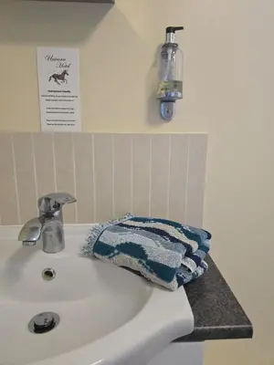 a bathroom sink with a towel sitting on it at Family Room - The Unicorn Hotel in Llanidloes