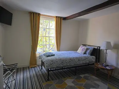 a bedroom with a bed and a large window at Cozy Double Room - The Unicorn Hotel in Llanidloes