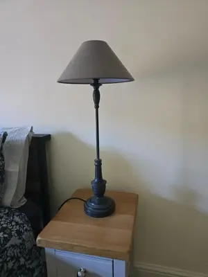 a black lamp sitting on a table next to a bed at Cozy Double Room - The Unicorn Hotel in Llanidloes