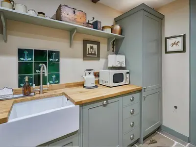 a kitchen with a counter top with a microwave at Rustic Retreat in Llangadog