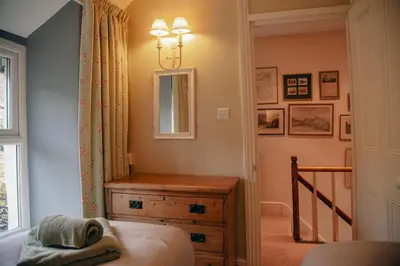 a small room with a dresser and a mirror at Little Cott - Cosy Welsh Cottage, a hiking retreat in Maentwrog
