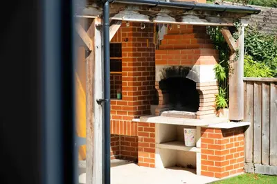 an outdoor pizza oven in a brick building at Finest Retreats - Elizabeth House in Kington