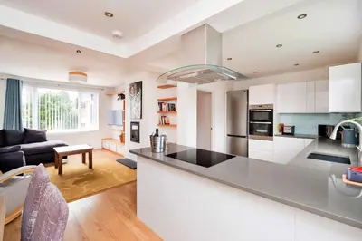 a kitchen and living room with a large counter top at Finest Retreats - Elizabeth House in Kington