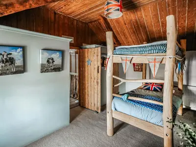 a bedroom with a bunk bed in a cabin at Ty Fferm Bargoed in Aberaeron