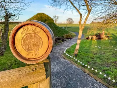 a wooden sign on a wooden post with a path at Shires End in Leominster