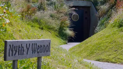a sign in front of a entrance to a door at The Willow Hill in Aberdyfi