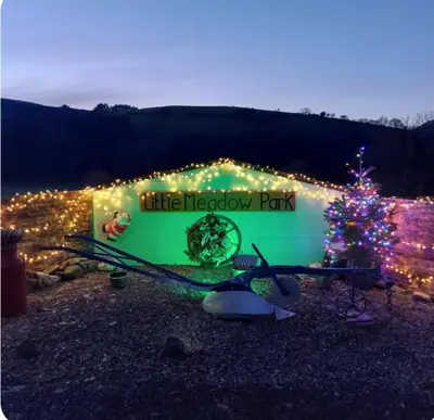 a park with a christmas tree and lights at Alpaca cabin-mountain view-hot tub-rural retreat in Llanbrynmair