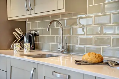 a kitchen counter with a sink and a bread on a cutting board at 3 Bed in Defynnog oc-p33133 in Devynock