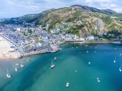 an aerial view of a beach with boats in the water at 2 Bed in Islawrdref oc-w33317 in Penmaenpool