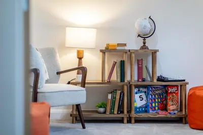 a book shelf filled with books next to a chair at 4 Bed in Llanigon oc-t33091 in Llanigon
