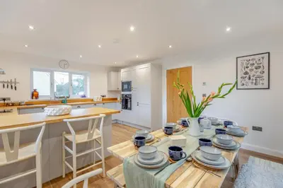 a kitchen with a table and a kitchen with a counter at 4 Bed in Llanigon oc-t33091 in Llanigon